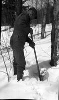 Worker digging a collection bucket out of the snow